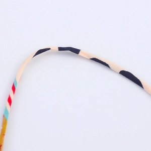 Detailed close-up of colorful striped print on a high-quality summer dress fabric
