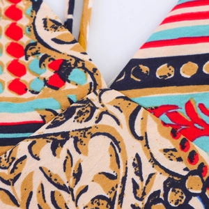 Detail of bohemian floral patchwork print and stitching on women's v-neck dress