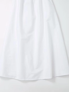 Detailed view of white V-neck dress fabric with smooth texture and flowing A-line hemline