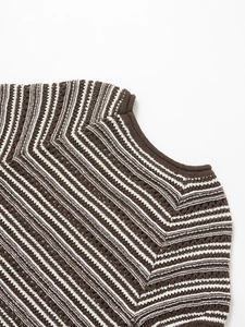 Macro detail of brown striped knitted top showing premium crochet hollow texture and neckline