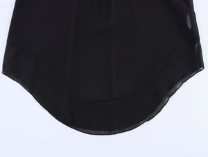 Detail view of the curved swallowtail hem on a sheer black chiffon longline shirt