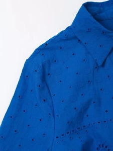 Macro detail of royal blue eyelet embroidery and stitching on this French style dress