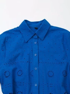Detail of navy blue cotton blouse featuring intricate floral eyelet embroidery and M size tag