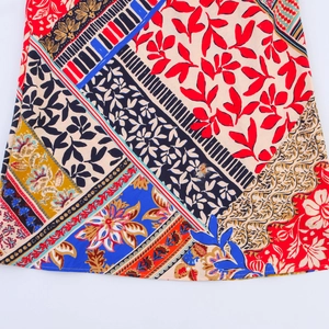 Detail of bohemian patchwork print dress showing geometric and floral patterns