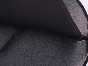 Macro detail of black chiffon fabric with premium overlock stitching and fine texture