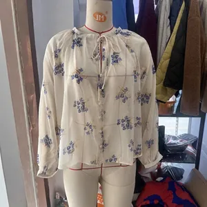 Women's floral chiffon blouse with long sleeves and elegant tie-neck detail in cream white