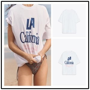 Detailed view of white cotton T-shirt featuring blue LA California graphic print design