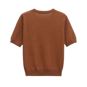 Detail view of caramel brown knit top showing ribbed hem and smooth fabric texture