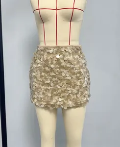 Detailed close-up showing layered circular sequins on a champagne mini skirt