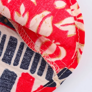 Close-up detail of double-sided floral and geometric fabric with fine stitching