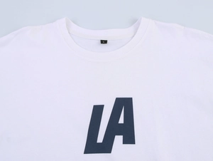 Detailed close-up of white cotton T-shirt neckline with size S tag and LA graphic print