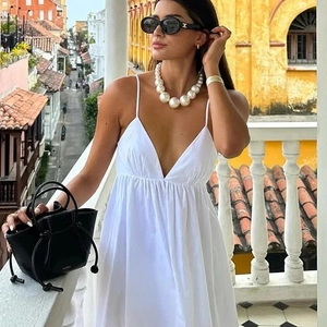 Elegant white V-neck backless maxi dress for women with thin straps and a flowy silhouette