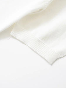 Macro shot of fine white ribbed knit fabric texture on short sleeve cuff detail