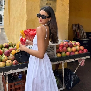 Elegant white backless maxi dress with thin straps for women summer beach vacation style