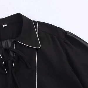 Women's black chiffon long-sleeve blouse with silver piping and bow tie collar