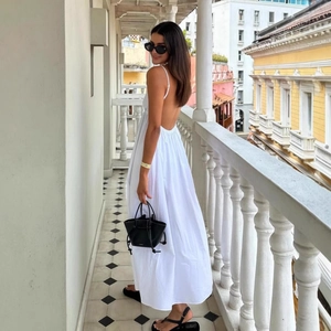 Elegant white backless maxi dress with V-neck and thin straps for a stylish summer look