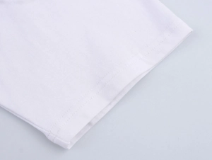 Close-up of white cotton T-shirt sleeve with high-quality double-needle stitching details