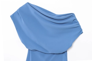 Detailed close-up of light blue one-shoulder dress with elegant pleated neckline texture