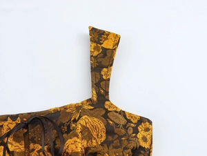 Close-up of vintage brown floral jacquard fabric texture with satin bow detail