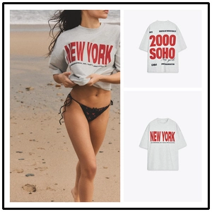Detail of New York and Soho red letter print on oversized grey cotton graphic T-shirt