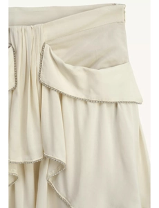 Detailed view of the ivory ruffled dress with bead embellishments and hidden side zipper