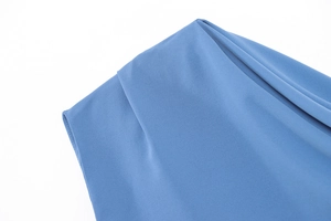 Detailed close-up of blue off-shoulder dress neckline with fine stitching and smooth fabric