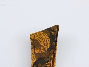 Close-up of elegant floral jacquard fabric with gold embroidery and premium stitching