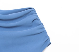Detailed view of the royal blue dress showing side ruching and premium textured fabric