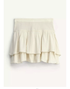 Detailed macro view of beige tiered ruffle skirt with shimmering beadwork and sequins
