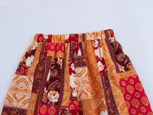 Close-up of bohemian floral print pants showing the elastic high waist and fabric texture