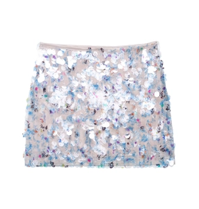 Detail view of shimmering white sequins over abstract floral print on an A-line mini skirt