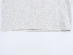 Macro shot of heather grey cotton fabric showing precise stitching on the hemline