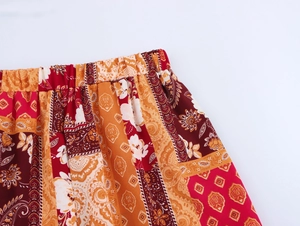 Detail of bohemian patchwork print on the elastic high waist of casual summer trousers
