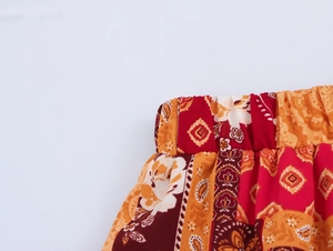 Detailed close-up of elastic waistband on bohemian printed casual summer trousers