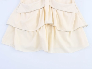 Close-up of French style tiered ruffle skirt showing delicate metallic beaded hem details