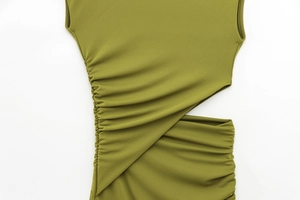 Detail view of olive green dress featuring side cut-out and ruched texture fabric