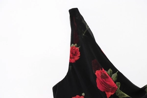 Close-up of red rose floral print on black chiffon fabric for a slim-fit summer dress
