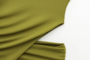 Detail view of olive green knitted fabric with side cut-out and neat stitching seams