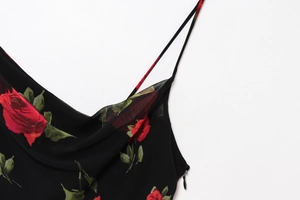 Detail of floral chiffon dress showing red roses print and discreet side zipper
