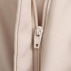 Detail view of the high-quality zipper and fine stitching on beige summer shorts