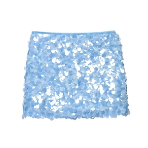Close-up of light blue mini skirt featuring large shimmering sequins and fine textures