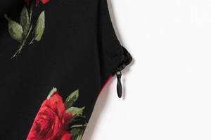 Detail view of the hidden back zipper and red rose print on French floral dress fabric