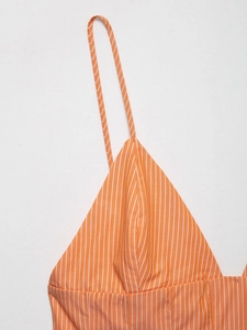Detailed macro view of orange and white vertical stripes on cotton camisole top fabric