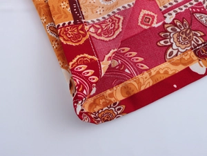 Detail view showing intricate bohemian paisley print fabric with neat stitching seams