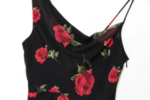 Close-up of cowl neck detail and red rose print on a black floral summer slip dress