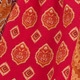 Detail of red and orange ethnic pattern print on loose fit casual summer fabric