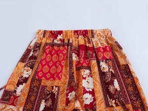 Close-up of elastic waistband on bohemian print pants with floral paisley pattern