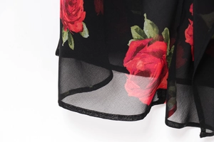 Close-up of lightweight black chiffon fabric with vibrant red rose floral print details