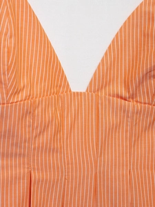 Close-up of orange and white striped cotton poplin top with vertical pleats and V-neckline
