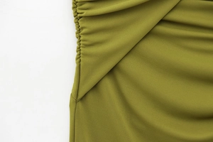 Detail shot of olive green sleeveless dress featuring ruched side seams and premium texture